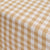 Close-up of a checkered tablecloth with beige and white pattern
