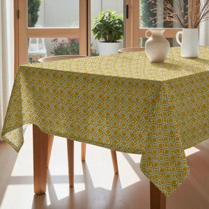 Yellow patterned tablecloth on a dining table with chairs and decor.