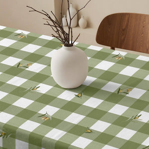 Green and white checkered tablecloth with a vase on a table