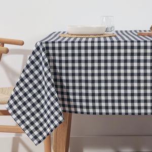 Table with a navy and white checkered tablecloth in a minimalistic setting