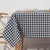 Table with a navy and white checkered tablecloth in a minimalistic setting