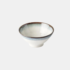 White ceramic bowl with a blue rim on a light gray background