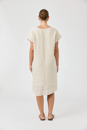 Person wearing a beige dress on a white background