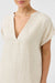 Beige dress worn by a person on a white background