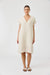 Woman wearing a beige dress on a white background