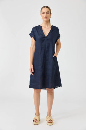 Woman wearing a navy blue dress on a white background