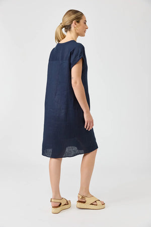 Woman wearing a navy blue dress on a white background