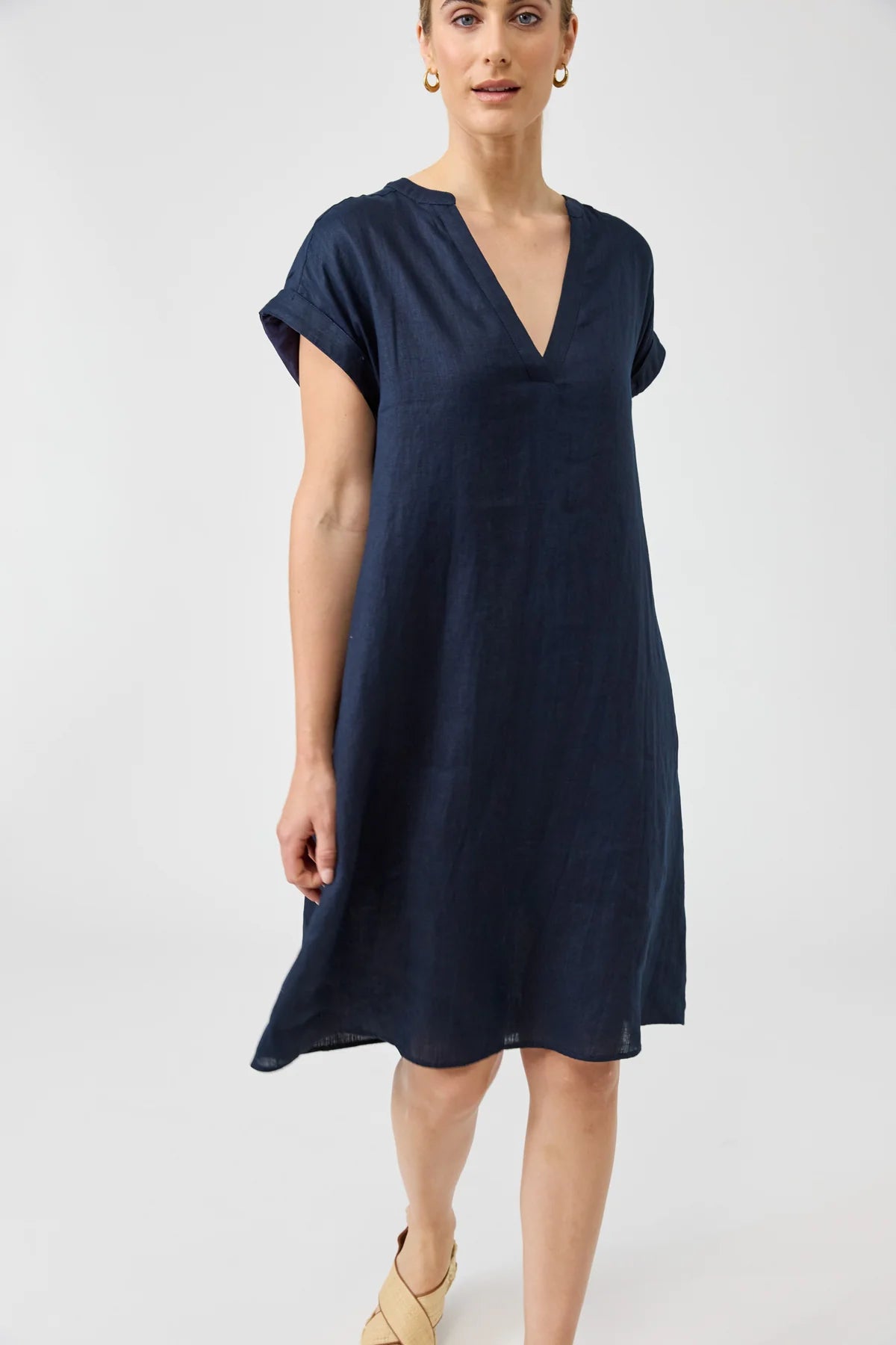 Woman wearing a navy blue dress on a white background