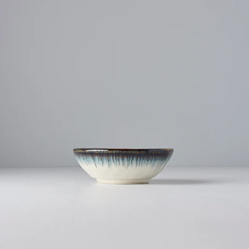 Ceramic bowl with a textured rim on a light gray background