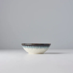Ceramic bowl with a textured rim on a light gray background