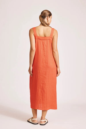 Woman wearing an orange dress on a white background
