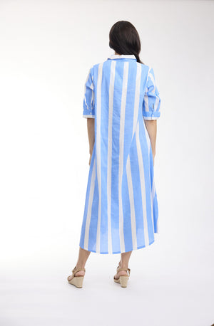 A woman viewed from behind wearing a light blue and white vertically striped midi shirt dress with short sleeves and beige wedge sandals, set against a plain white studio background.