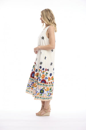 A woman modeling a sleeveless midi dress with a white base and a colorful floral and geometric border print, shown in profile against a white studio background.