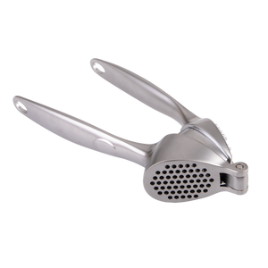 Metallic garlic press on a white background