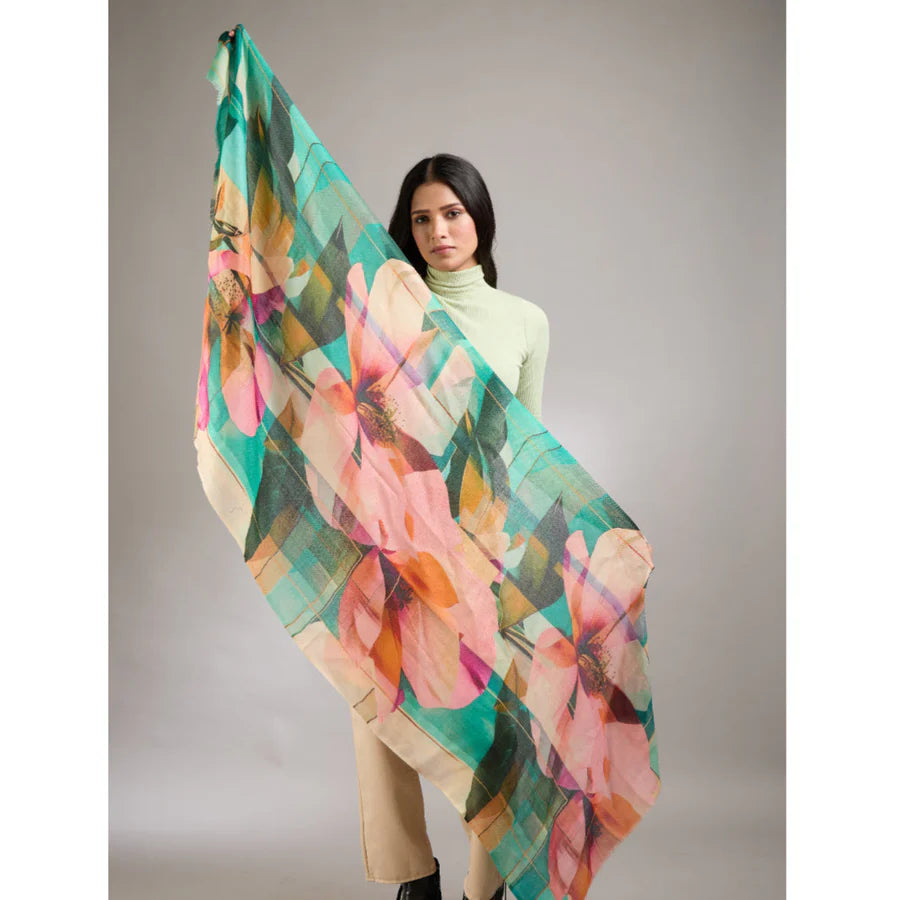 Woman holding a colorful floral scarf against a neutral background