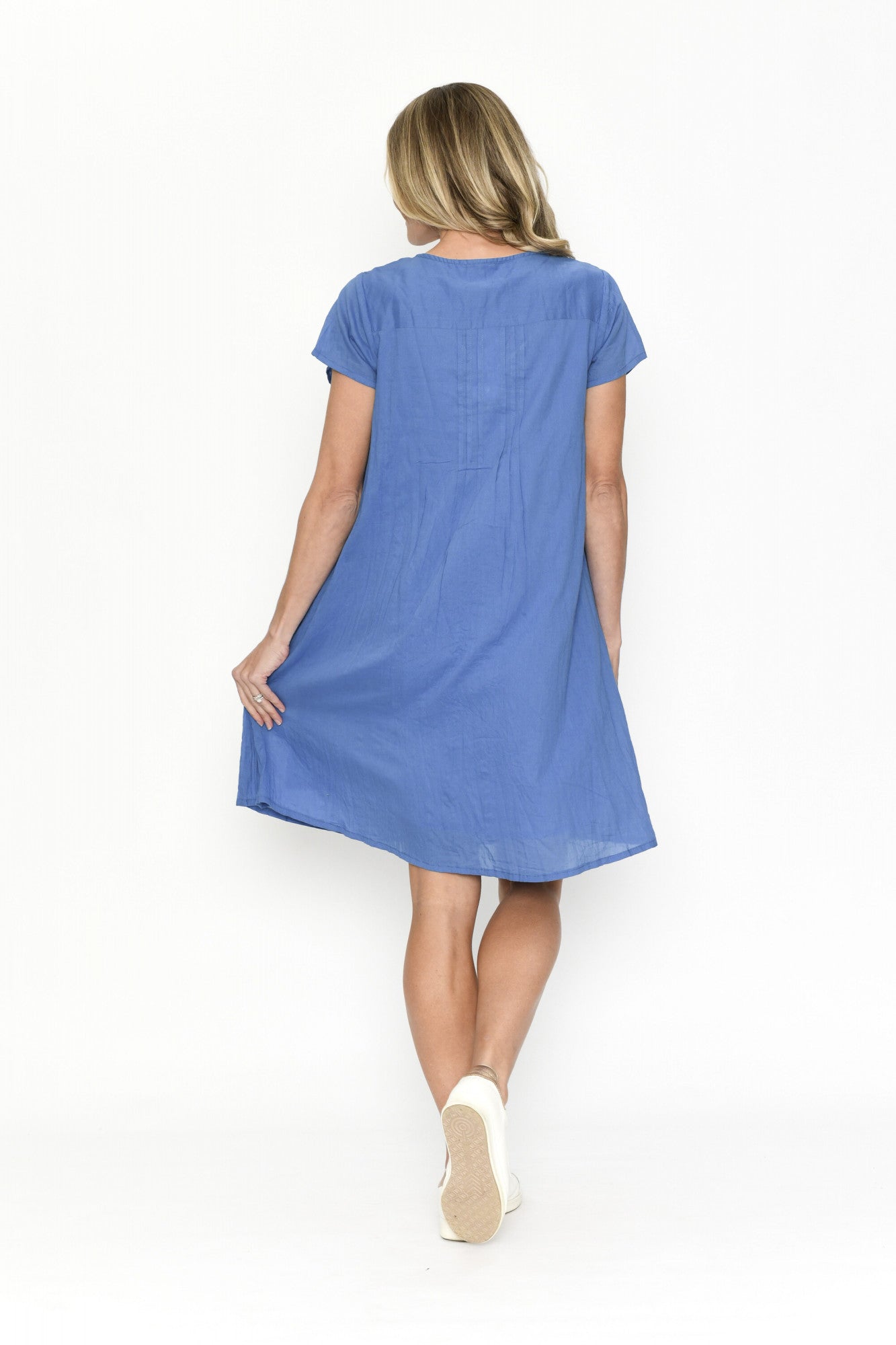 Woman wearing a blue dress on a white background