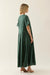 Woman wearing a green dress against a white background