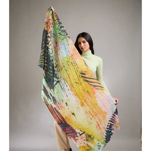 Woman holding a colorful scarf with a neutral background