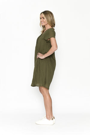 Woman wearing an olive green dress on a white background