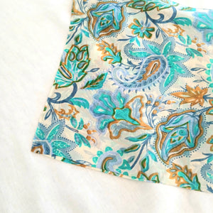 Floral patterned fabric with blue and orange colors on a white background