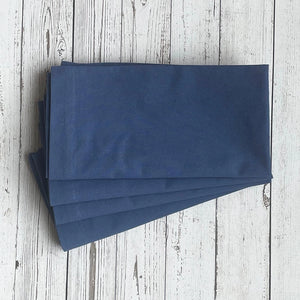 Stack of blue napkins on a wooden surface