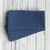 Stack of blue napkins on a wooden surface