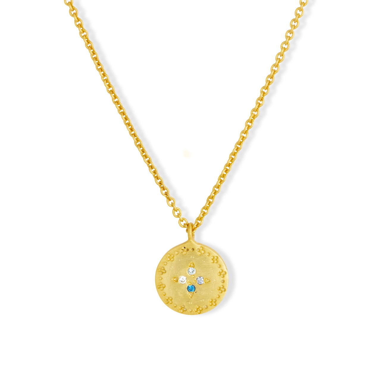 Gold necklace with a round pendant on a white background