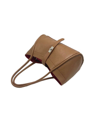 Tan handbag with a strap on a white background