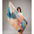 Woman holding a colorful scarf against a plain background