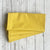 Yellow fabric napkins on a wooden surface