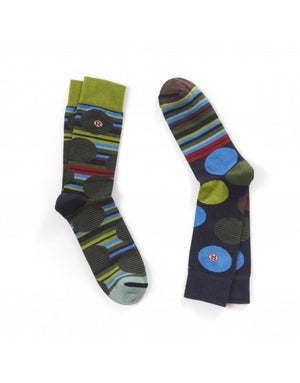 A pair of crew socks with a colorful abstract pattern of stripes and circles in olive green, blue, red, and dark gray on a dark navy base, displayed on a clean white background.