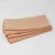 Stack of folded nude napkins on a white background