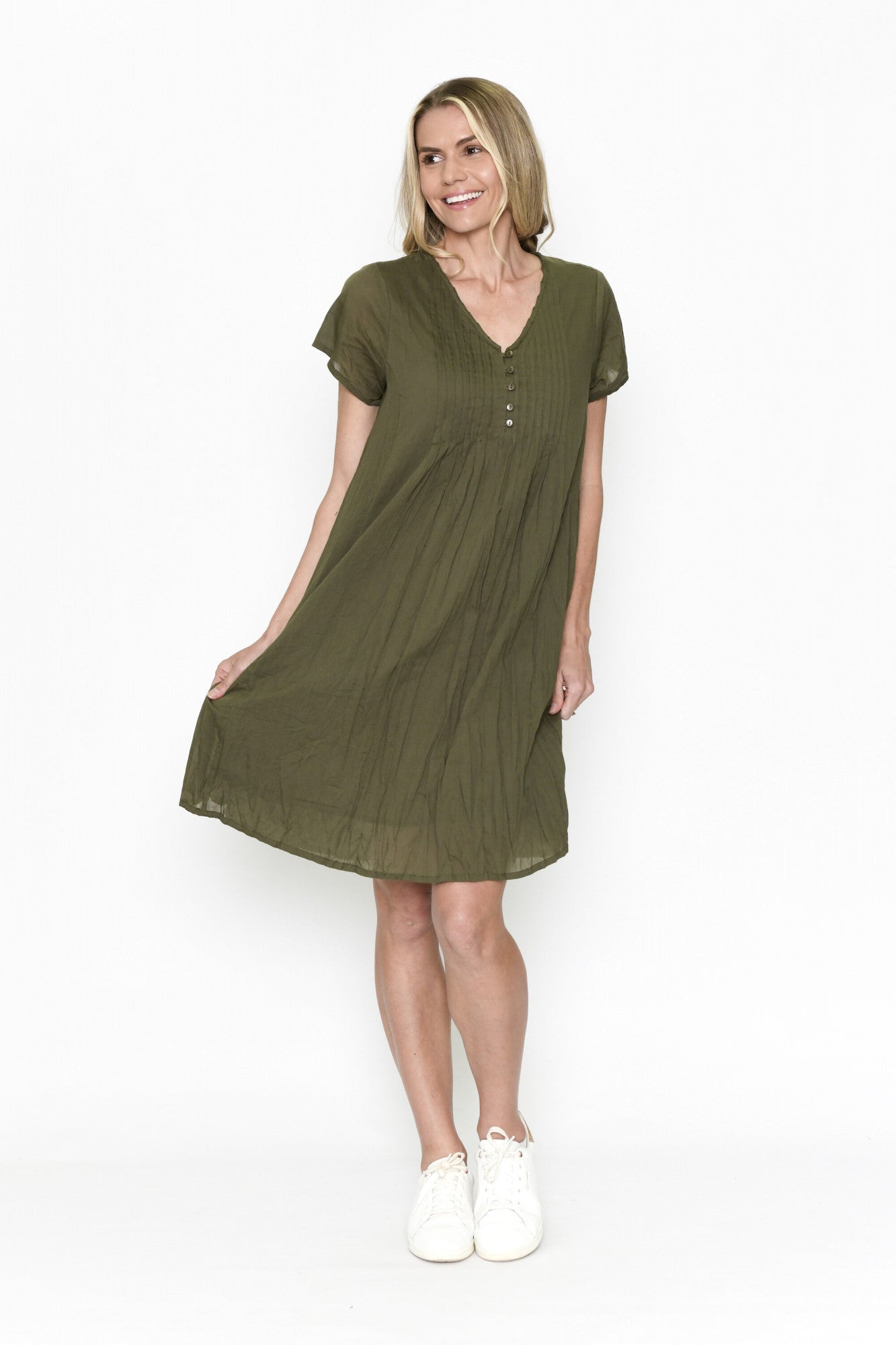 Woman wearing a green dress on a white background