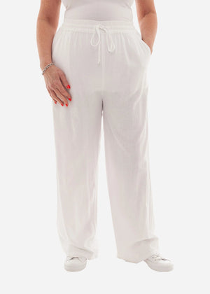 Person wearing white wide-leg pants on a white background