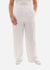 Person wearing white wide-leg pants on a white background