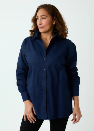 Woman wearing a navy blue shirt against a white background