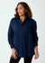 Woman wearing a navy blue shirt against a white background
