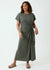 Woman wearing a green dress with a knot detail on a white background