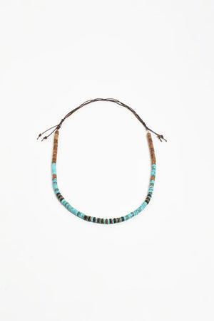 Necklace with blue beads on a white background