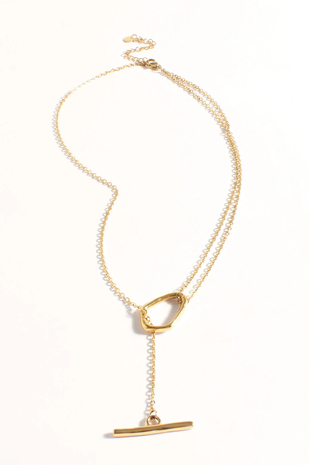 Gold necklace with a unique clasp on a white background