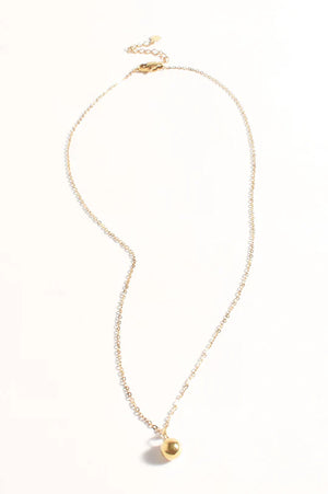 Gold necklace with a small pendant on a white background