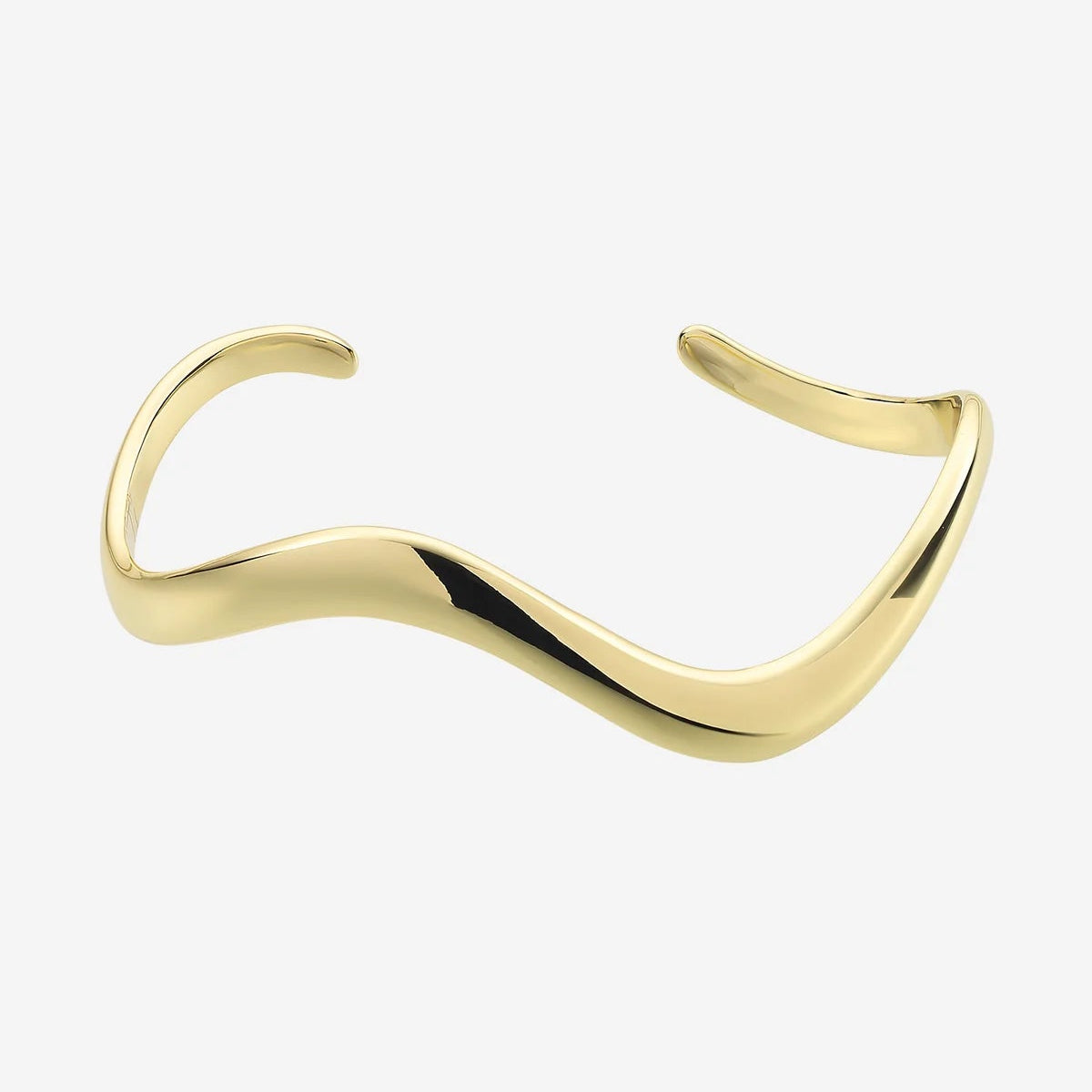Gold bracelet on a wrist with a white top