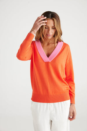 Orange jumper with contrast pink v-neck