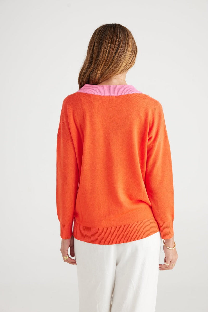 Orange jumper with contrast pink v-neck