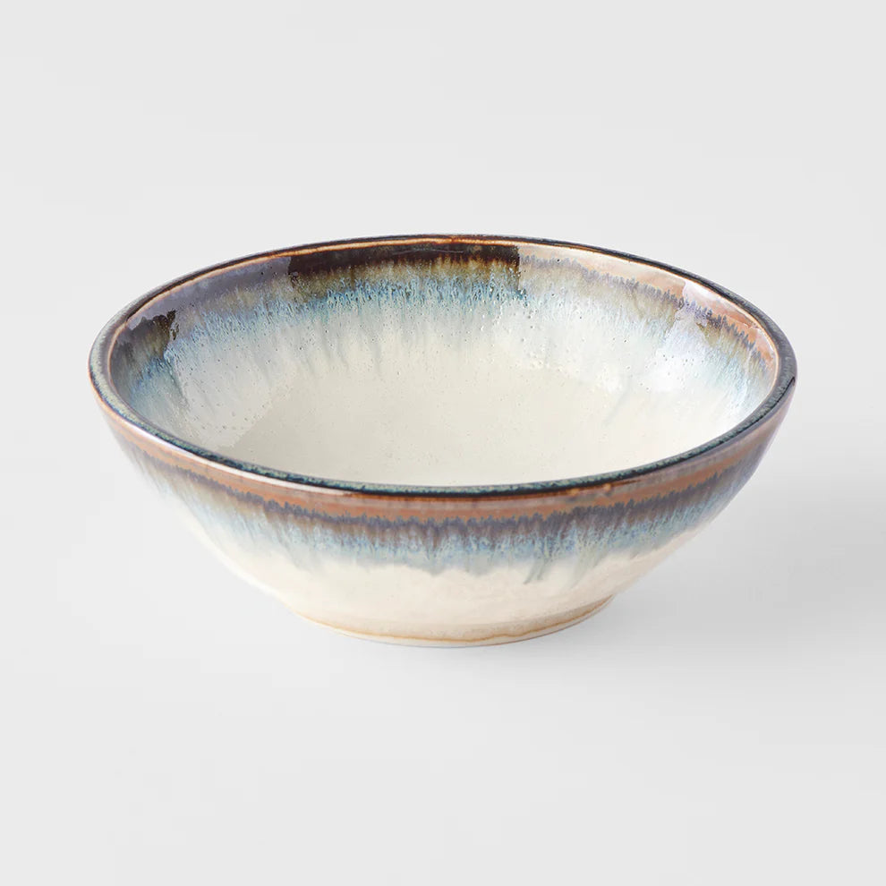 Ceramic bowl with a textured rim on a light gray background