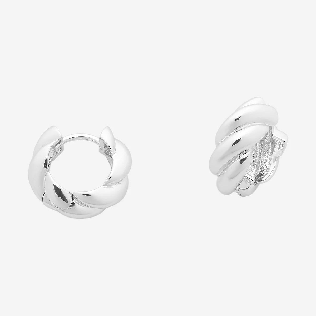 Rope style silver huggies on a white background