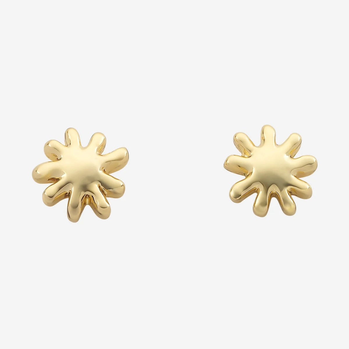 Gold sun-shaped earrings on a white background