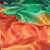 Close-up of colorful fabric with red, green, and orange hues.
