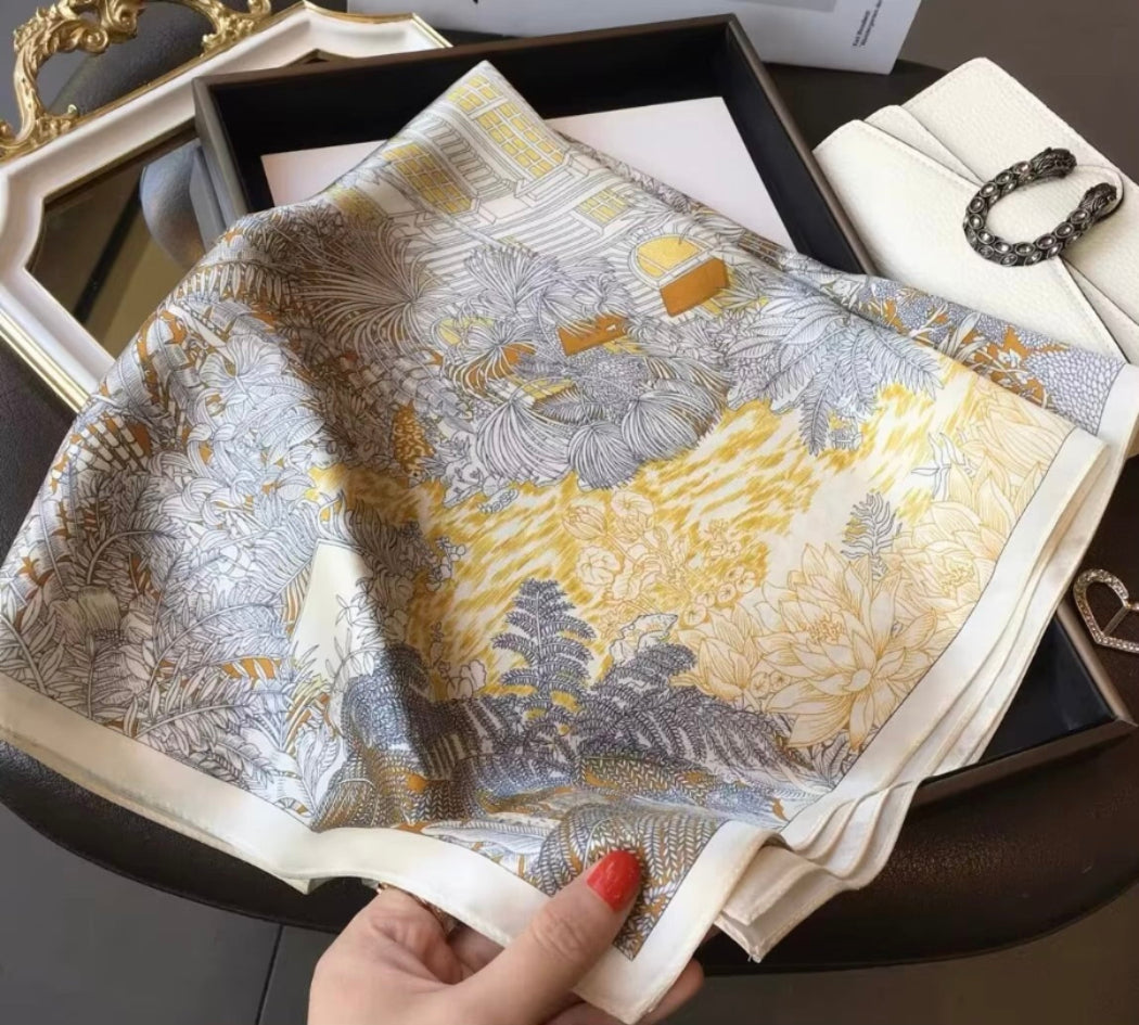 Patterned silk scarf held by hand