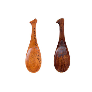 Two wooden spoons with decorative patterns on a white background